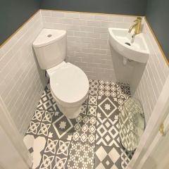 Latina Black Patterned floor tiles in a small cloakroom