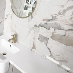 Vermont gold mirror polished porcelain tiles bathroom setting with gold taps and mirror