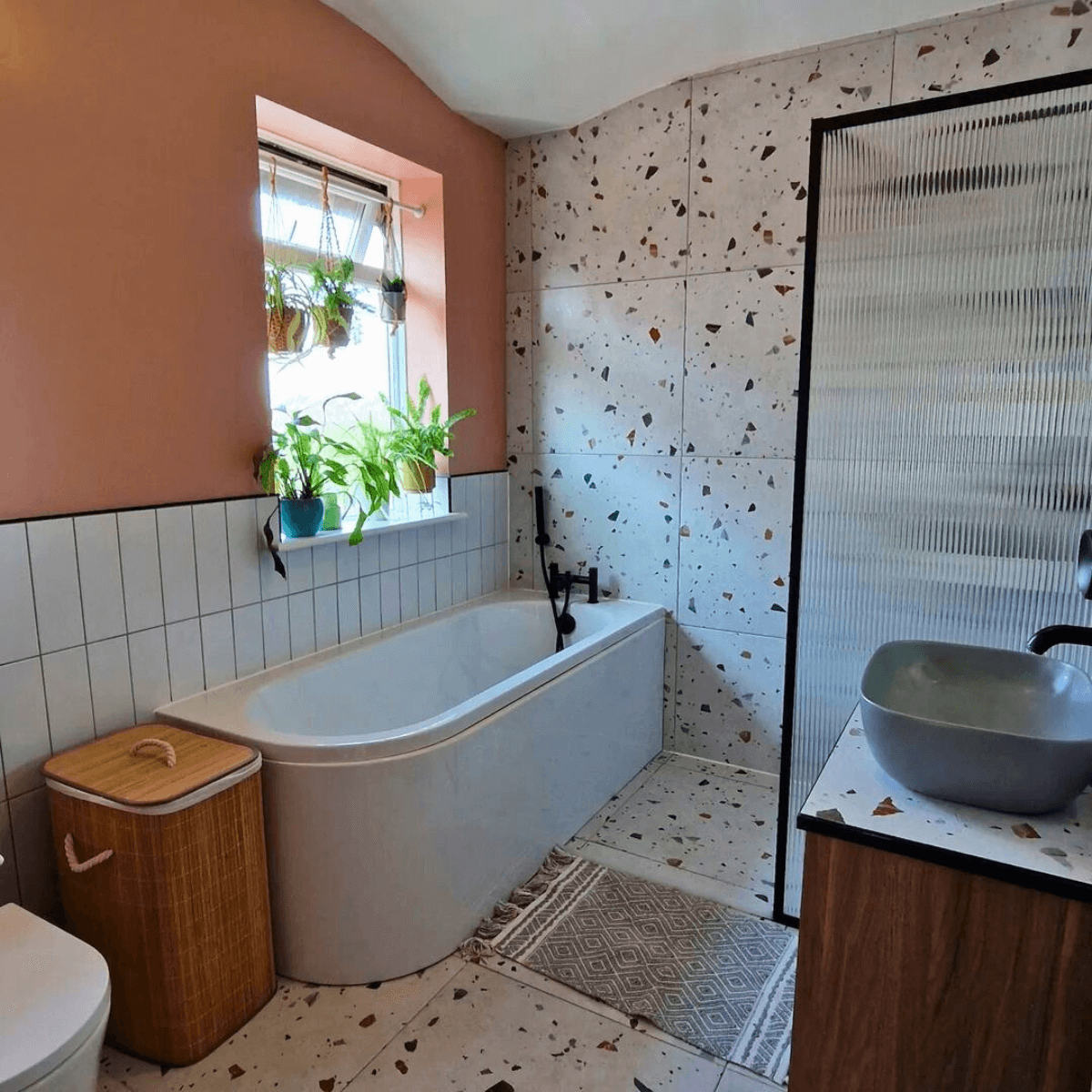 floor to ceiling design of galaxy terrazzo wall and floor tiles in a bathroom with a fluted shower screen