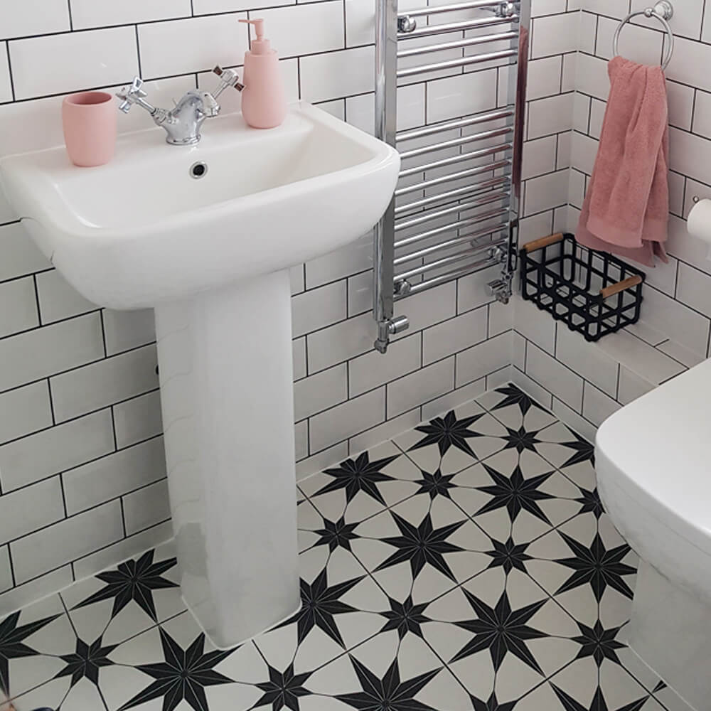 black star pattern tiles on a floor in a small bathroom