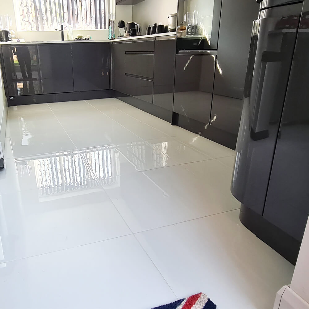 bright white polished floor tiles in a kitchen setting