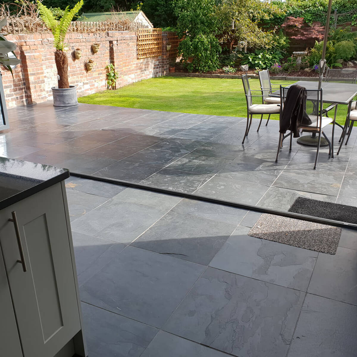 Large slip resistant slate floor tiles in an indoor outdoor setting